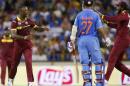 West Indies bowler Kemar Roach, left, celebrates with teammate Chris Gayle, right, after dismissing Indian batsman Ajinkya Rahane during their Cricket World Cup Pool B match in Perth, Australia, Friday, March 6, 2015. (AP Photo/Theron Kirkman)