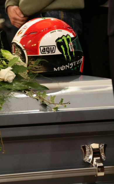 The helmet of Late MotoGp rider Marco Simoncelli is seen on the coffin during the funeral service in the Santa Maria church in Coriano, Italy, Thursday, Oct. 27, 2011. Italian sport was in shock after