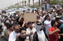 Filr photo of Iraqi mourners carrying coffin of Shi'ite militia fighter killed in clashes with Free Syrian Army, during a funeral in Basra