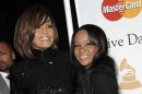 FILE - In this Feb. 12, 2011 file photo, singer Whitney Houston, left, and her daughter Bobbi Kristina arrive at the Pre-Grammy Gala & Salute to Industry Icons with Clive Davis honoring David Geffen in Beverly Hills, Calif. Bobbi Kristina Brown has been spotted wearing a sparkly bauble on her ring finger, but she's not planning on getting married anytime soon. A rep for Brown's mother, the late Whitney Houston, says the 19-year-old is â€œsimply wearing her mother's ringâ€ and that she's not engaged. (AP Photo/Dan Steinberg, file)