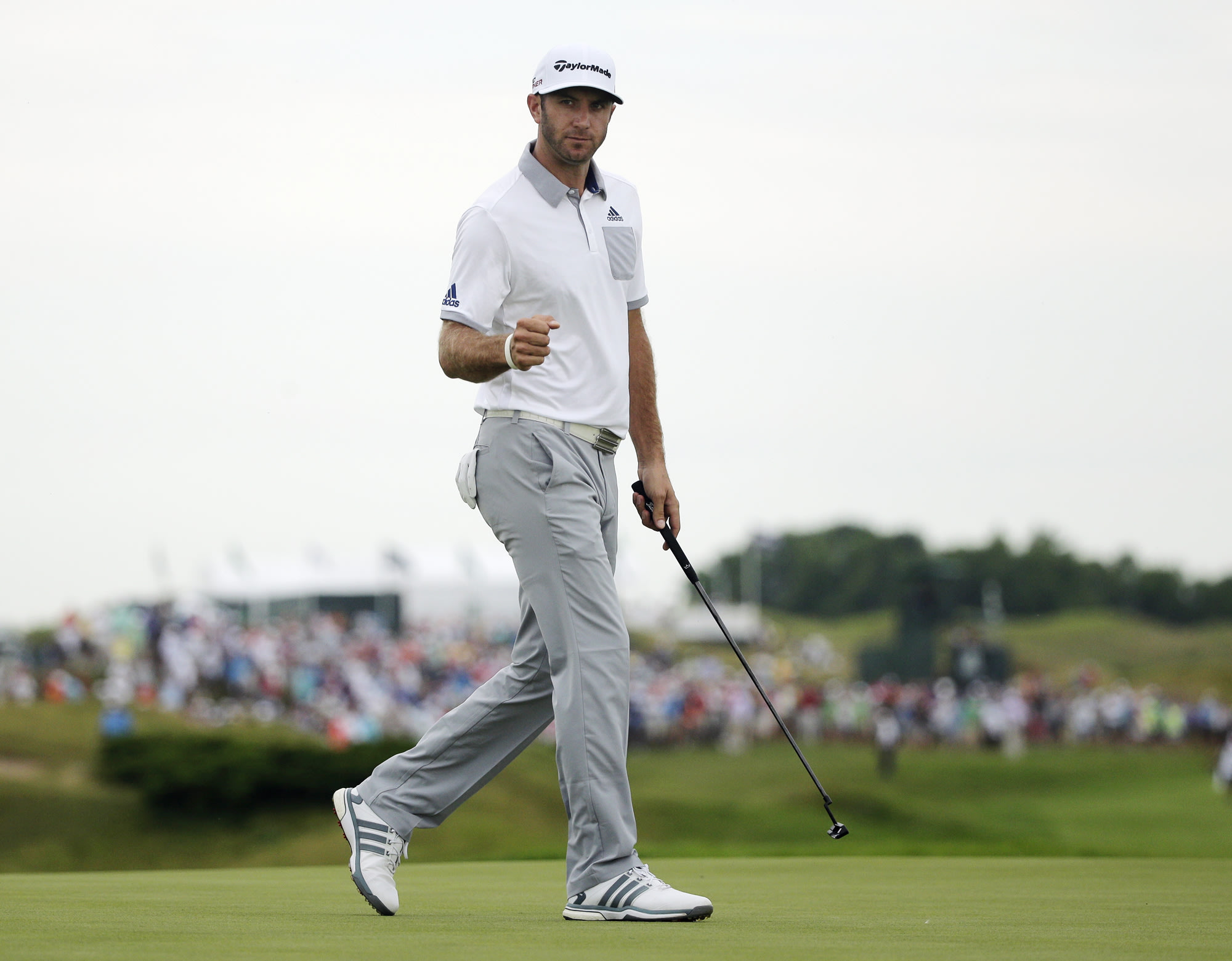 Dustin Johnson reacts after making an eagle putt on the 16th hole. (AP)
