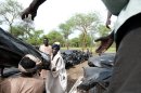 Aid workers load tents for refugees from Blue Nile at Yusuf Batil Refugee camp in South Sudan on June 23, 2012