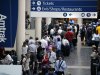 Travelers wait in line to board Amtrak's Northeast Regional train to Boston at Union Station in Washington, Friday, Aug. 26, 2011. (AP Photo/Cliff Owen)