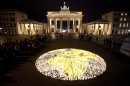 About 5000 candles arrange to a globe lights in front of the Brandenburg Gate prior to the landmark switched off the lights to mark 'Earth Hour' in Berlin, Saturday, March 31, 2012. Earth Hour takes place worldwide at 8.30 p.m. local time and is a global call to turn off lights for 60 minutes in a bid to highlight the global climate change. (AP Photo/Markus Schreiber)