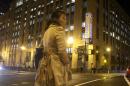 In this Monday, Nov. 4, 2013, photo, a woman stands across the street from Twitter headquarters in San Francisco. As Wall Street analysts size up Twitter ahead of its first public stock sale this week, more than a few are expressing concern about the company's lack of profits. (AP Photo/Jeff Chiu)