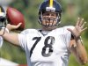 Pittsburgh Steelers quarterback Ben Roethlisberger wears the practice jersey of former teammate Max Starks during training camp at the NFL football team's practice facility in Latrobe, Pa., on Sunday, July 31, 2011. After practice, Roethlisberger said he saw the jersey in Stark's old locker and decided to wear it to honor him. (AP Photo/Keith Srakocic)
