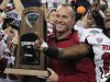 Northern Illinois coach Dave Doeren holds the Mid-American Conference championship trophy after his team defeated Kent State 44-37 in double overtime in an NCAA college football game, Friday, Nov. 30, 2012 in Detroit. (AP Photo/Carlos Osorio)