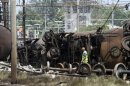 A rescue worker walks near a rail tanker car lies on its side after a derailment and explosion in Viareggio