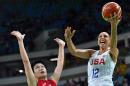 USA's guard Diana Taurasi (R) goes to the basket past Japan's small forward Yuka Mamiya during a Women's quarterfinal basketball match between USA and Japan at the Carioca Arena 1 on August 16, 2016 during the Rio 2016 Olympic Games