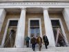 People leave the Bank of Greece as cleaning works are in progress, in central Athens