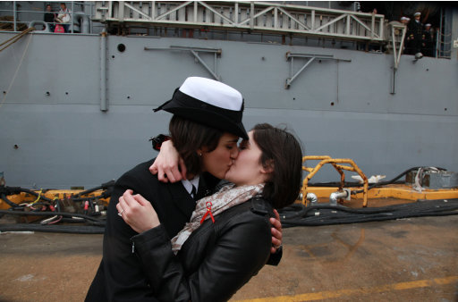 Petty Officer 2nd Class Marissa Gaeta, left, kisses her girlfriend of two years, Petty Officer 3rd Class Citlalic Snell at Joint Expeditionary Base Little Creek in Virginia Beach, Va., Wednesday, Dec. 22, 2011 after Gaeta's ship returned from 80 days at sea. It ís a time-honored tradition at Navy homecomings - one lucky sailor is chosen to be first off the ship for the long-awaited kiss with a loved one. On Wednesday, for the first time, the happily reunited couple was gay.  (AP Photo/The Virginian-Pilot, Brian J. Clark)  MAGS OUT