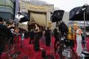 Members of the media take positions on red carpet ahead of the 86th Academy Awards in Hollywood