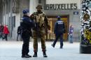 A Belgian soldier speaks to a police officer outside Brussels Central Station following attacks in Brussels on March 22, 2016