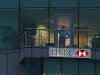 A man uses a mobile phone in a branch of HSBC in St Helier, Jersey