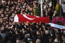People carry the coffin of Yunus Gormek, 23, one of the victims of the Reina night club attack, during his funeral ceremony on January 2, 2017 in Istanbul