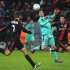 Messi (C) controls for the ball under pressure from Leverkusen defender Daniel Schwaab (L)