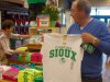 Buck Striebel holds up a University of North Dakota Fighting Sioux T-shirt while his wife, GaeLynn, sorts through other shirts on sale at a sporting goods store in Bismarck, N.D., Tuesday, June 12, 2012. Buck Striebel, a graduate of North Dakota State University, said he would vote to keep the nickname of the rival school. GaeLynn, and the couple’s son, Robert, are UND graduates and said they would vote to get rid of the controversial nickname. (AP Photo/James MacPherson)