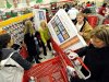 FILE - In this Nov. 25, 2011 file photo, shoppers scramble for door buster deals at Target, in Bowling Green, Ky. U.S. consumers spent at a lackluster rate in November as their incomes barely grew, suggesting that U.S. households may struggle to sustain their spending into 2012.(AP Photo/Daily News, Joe Imel, File)