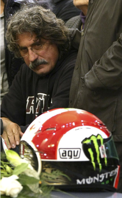 Late MotoGp rider Marco Simoncelli's father Paolo attends the funeral for his son in the Santa Maria church in Coriano, Italy, Thursday, Oct. 27, 2011. Italian sport was in shock after Marco Simoncell