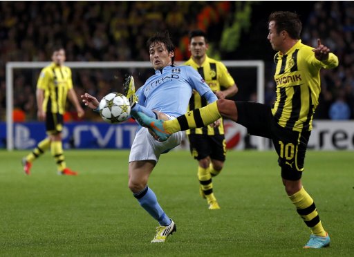 Manchester City's Silva is challenged by Borussia Dortmund's Gotze during their Champions League Group D soccer match in Manchester