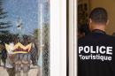 A member of the Tunisian security forces stands guard near a bullet hole on a window at the Riu Imperial Marhaba Hotel in Port el Kantaoui on June 29, 2015