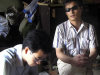 FILE - In this undated file photo released by his supporters, blind activist Chen Guangcheng, right sits in a village in China.  Rights activists have criticized a Hollywood studio for filming a buddy comedy in an eastern Chinese city where the blind, self-taught activist lawyer is being held under house arrest and reportedly beaten.  Relativity Media is shooting part of the comedy "21 and Over" in Linyi, a city in Shandong province where the activist Chen's village is located. Authorities have turned Chen's village of Dongshigu into a hostile, no-go zone and activists, foreign diplomats and reporters have been turned back, threatened and had stones thrown at them by men patrolling the village. (AP Photo/Supporters of Chen Guangcheng, File)