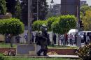 Egyptian security forces inspect the scene after two homemade bombs went off near the presidential palace in Cairo, Egypt, Monday, June 30, 2014. The bombs killed a senior police officer and wounded many people, security officials said. (AP Photo/Ahmed Abdel Fattah, El Shorouk Newspaper) EGYPT OUT
