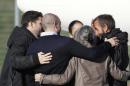 Former French hostage Daniel Larribe (right) is welcomed by his family on his arrival with three other hostages at the military airport of Villacoublay outside Paris, on October 30, 2013
