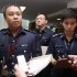 Superintendent Ho assistant director of media relations of Singapore Police Force, listens to questions from journalists on the international match-fixing scam at the Ministry of Home Affairs in Singapore