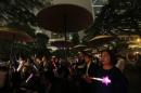 People wave luminous sticks as they take part in an anti-Occupy Central rally at Hong Kong's financial Central district
