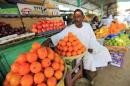 A vegetable vendor waits for customers at his shop in Khartoum