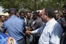 Papua New Guinea police hold back protesters as Peter O'Neill greets (R) supporters in 2011