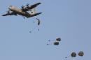 Paratroopers jump from a Lockheed Martin C-130J Super Hercules in Pokhran, India during military exercises, on February 19, 2013