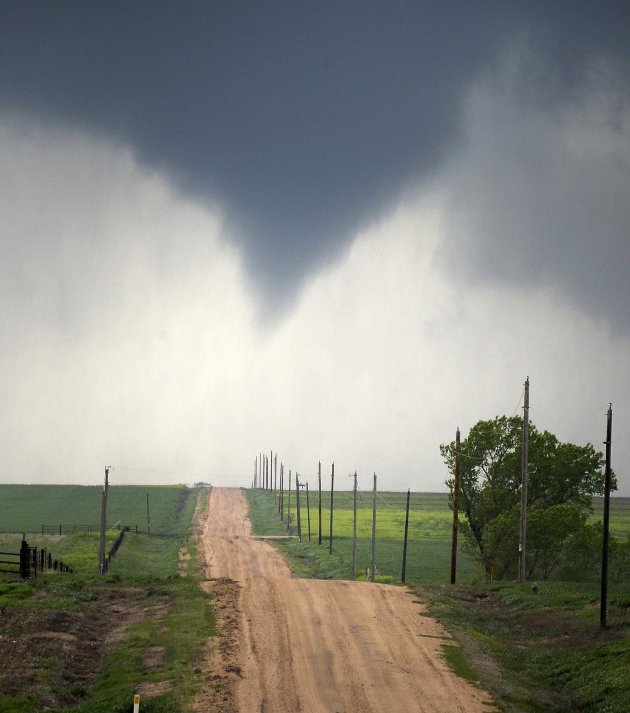 A tornado makes its way through farmlands near Rush Center
