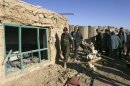Afghan policemen inspect a police post after a night raid by U.S. troops in Ghazni province