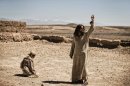 This publicity image released by History shows Diogo Morcaldo as Jesus, right, in a scene from "The Bible," on History. The producers of the cable TV miniseries on the Bible say Internet chatter that their Satan character resembles President Barack Obama is "utter nonsense." Mark Burnett and Roma Burnett said Monday the Moroccan actor who played Satan in the History channel series has played Satanic characters in other Biblical programs long before Obama was elected president. (AP Photo/History, Joe Alblas)
