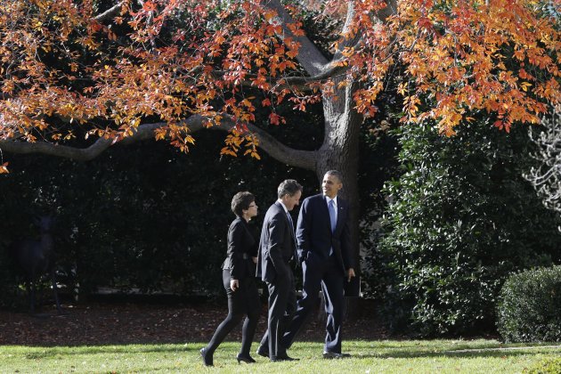 President Barack Obama walks with Treasury Secretary Timothy Geithner and White House senior adviser Valerie Jarrett on the South Lawn of the White House in Washington, Wednesday, Dec. 5, 2012, as they returned from the Business Roundtable, an association of chief executive officers, where the president spoke about the fiscal cliff. (AP Photo/Charles Dharapak)