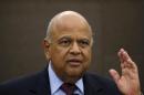 South African Finance Minister Pravin Gordhan reacts during a media briefing in Sandton near Johannesburg