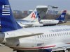 An American Airlines plane is seen between two US Airways Express planes at the Ronald Reagan Washington National Airport in Virginia