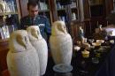 General Director of the Spanish Guardia Civil, Arsenio Fernandez, looks at some of the Egyptian archeological pieces displayed in Madrid's National Archeological Museum on January 28, 2015