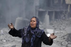 A Palestinian woman reacts at seeing destroyed homes &hellip;