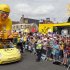 A Le Credit Lyonnais vehicle from the publicity caravan of the Tour de France travels past spectators at the start of the third stage of the 99th Tour de France cycling race between Orchies and Boulogne-sur-Mer
