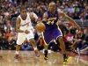 Los Angeles Lakers' Kobe Bryant drives past Los Angeles Clippers' Chris Paul during the second half of their NBA basketball game in Los Angeles