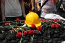 flowers on some coal and a hard hat