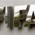 Water flows over the FIFA logo in front of the FIFA headquarters during heavy rainfall in Zurich