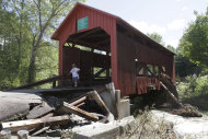A damaged historic covered bridge spans Cox Brook in Northfield, Vt., Monday, Aug. 29, 2011, the day after Tropical Storm Irene dumped heavy rainfall across the region, causing flash floods. (AP Photo/Toby Talbot)