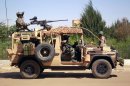 French special forces drive through the city of Gao, Northern Mali, Wednesday Jan. 30, 2013. Islamist extremists fled the city Saturday after French, Chadian and Nigerien troops arrived, ending 10 months of radical islamic control over the city.(AP Photo/Jerome Delay)