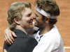 US Davis Cup team captain Jim Courier, left, celebrates with his player Mardy Fish after winning the double match against Swiss Davis Cup tennis players Roger Federer and Stanislas Wawrinka during the Davis Cup World Group first round double match between Switzerland and the US in the Forum Arena in Fribourg, Switzerland, Saturday, Feb. 11, 2012. (AP Photo/Keystone, Peter Klaunzer)