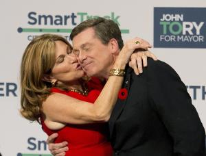 John Tory, right, receives a kiss from his wife Barbra …
