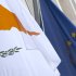 The Cypriot, left, and EU flag are seen at the Cypriot delegation building in Brussels on Sunday, March 24, 2013. The EU says a top official will chair a high-level meeting on Cyprus in a last-ditch effort to seal a deal before finance ministers decide whether the island nation gets a 10 billion euro bailout loan to save it from bankruptcy. (AP Photo/Virginia Mayo)
